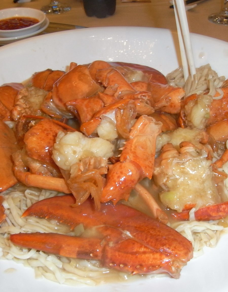A plated seafood dish with lobster and noodles