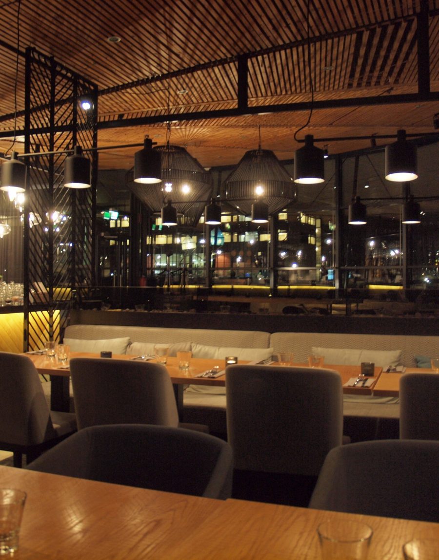 Warm-lit restaurant dining room interior in the evening