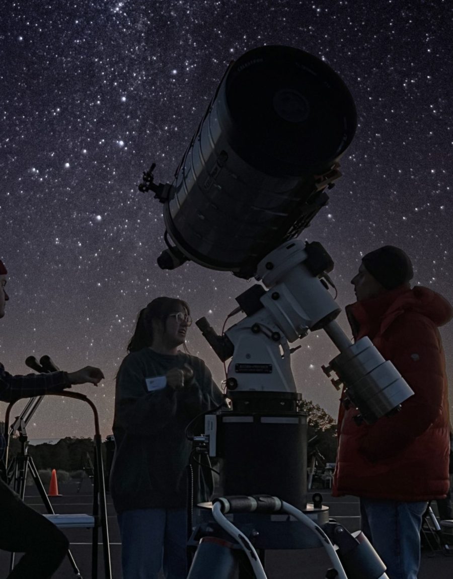 Telescope silhouetted against the Milky Way at a night star party