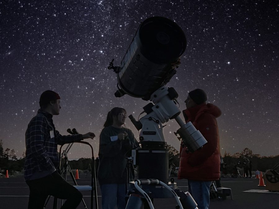Telescope silhouetted against the Milky Way at a night star party