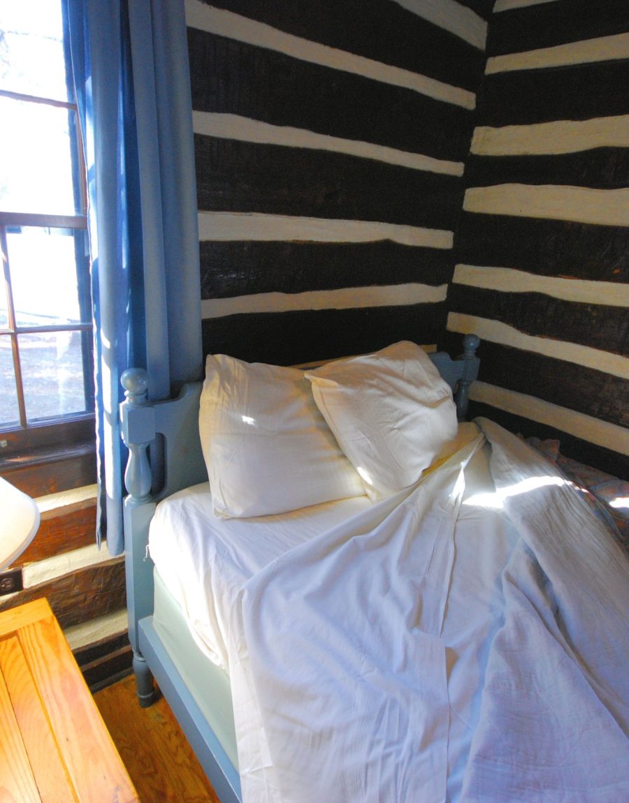 Rustic wood cabin bedroom interior with a window