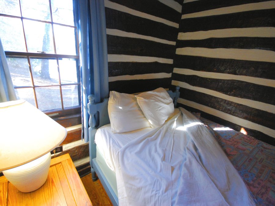 Rustic wood cabin bedroom interior with a window
