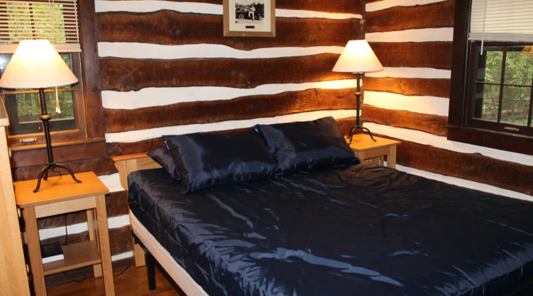 Cozy log cabin bedroom interior with a queen bed